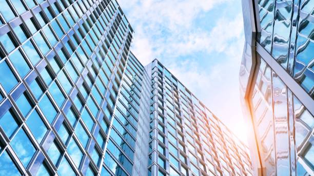 istock Modern office building with glass facade on a clear sky background. 1315797008