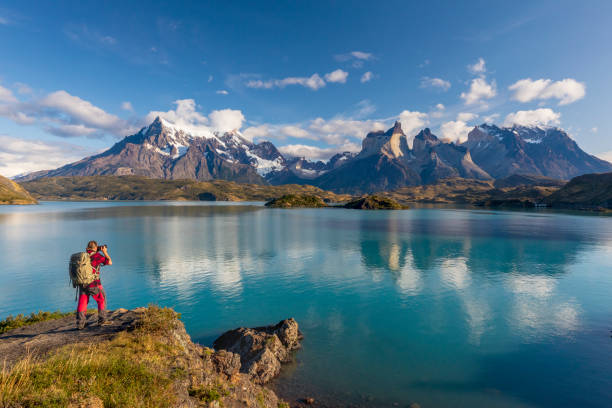 Photographer in Torres del Paine at Lago Pehoe Photographer in Torres del Paine at Lago Pehoe chile stock pictures, royalty-free photos & images