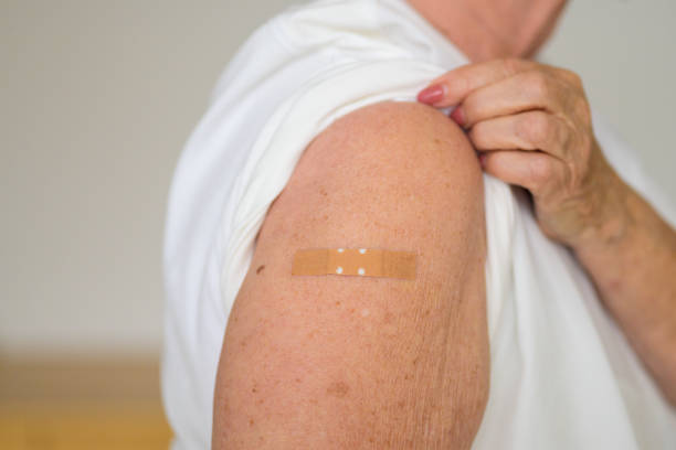 istock Anonymous lady showing the plaster covering her vaccination site 1315798596