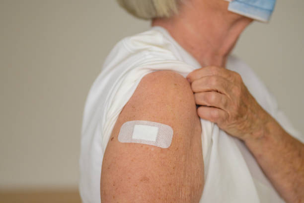 istock Anonymous lady showing the plaster covering her vaccination site 1315798689