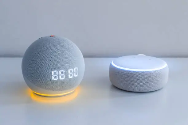 Photo of Voice controlled speaker with activated voice recognition, on light background.