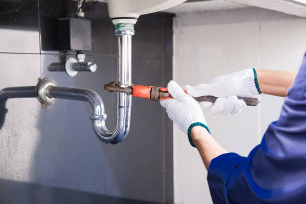 istock Plumber fixing white sink pipe with adjustable wrench. 1315800136