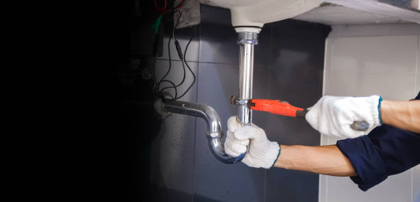 istock Plumber fixing white sink pipe with adjustable wrench. 1315800178