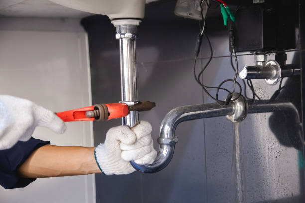 istock Plumber fixing white sink pipe with adjustable wrench. 1315800214