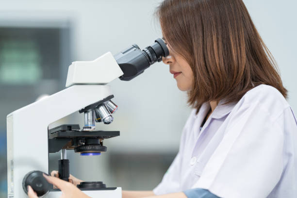 istock A young scientist woman in a laboratory coat looking through a microscope in a laboratory to do research and experiment. Scientist working in a laboratory. Education stock photo 1315800870