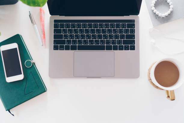 istock Top view of modern laptop or notebook with phone to work. Office desktop on table background. 1315803180