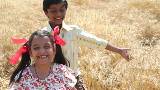 Two happy children playing in agricultural field