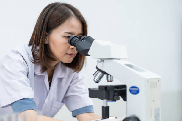 istock A young scientist woman in a laboratory coat looking through a microscope in a laboratory to do research and experiment. Scientist working in a laboratory. Education stock photo 1315803701