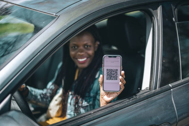 istock Young african female driver showing her immunization certificate app 1315816140