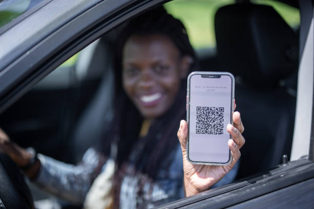 istock Young african female driver showing her immunization certificate app 1315816165