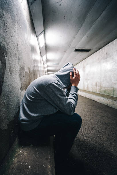 istock Homeless depressed man sitting in subway tunnel 1315818205