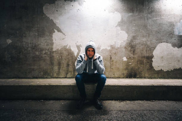 istock Homeless depressed man in dark subway tunnel 1315819567