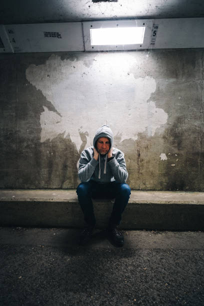 istock Homeless depressed man in dark subway tunnel 1315819569