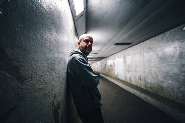 istock Homeless depressed man in dark subway tunnel 1315819590