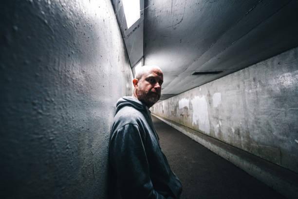 istock Homeless depressed man in dark subway tunnel 1315819592