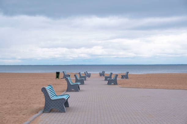 istock Retro beach with blue benches without people 1315821760