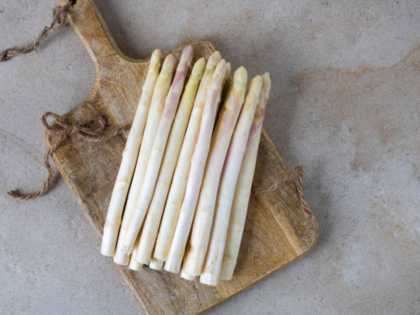 istock Raw white asparagus lies on a cutting board. Shooting from above 1315824728