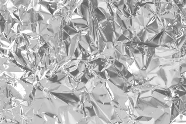 istock Shiny silver foil texture background, pattern of white grey wrapping paper with crumpled and wavy. 1315826047