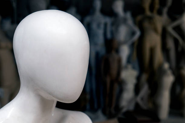 Head of a bald mannequin with a shirt on. The mannequin also wears a docking tie