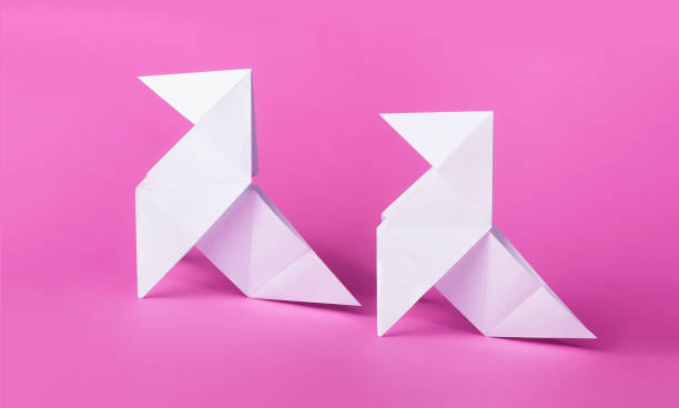 istock simple origami pigeons with pink background 1315830598