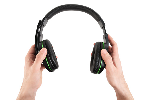 Men’s hand holding headphones (Clipping Path) on the white background