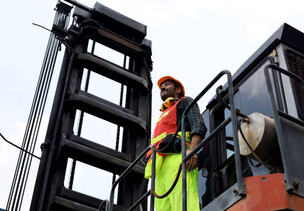 istock Young Engineers standing in the shipping yard tracking the cargo inventory and checking container box for safety. 1315832448