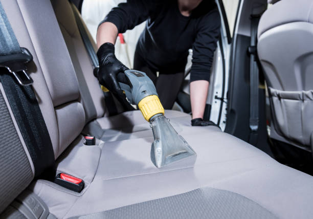 istock Worker cleans car interior with vacuum cleaner 1315835012