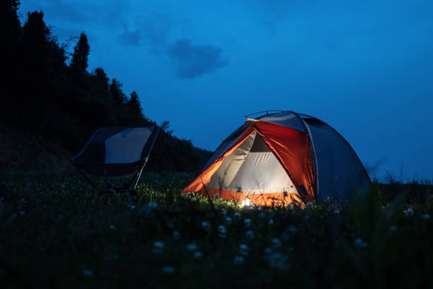 istock A lighted tent and a chair on the uphill at night 1315853047