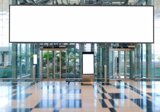 istock Blank advertising banner, billboard mockup in generic modern interior retail environment. Large digital display screen, an out-of-home OOH media display space 1315854254