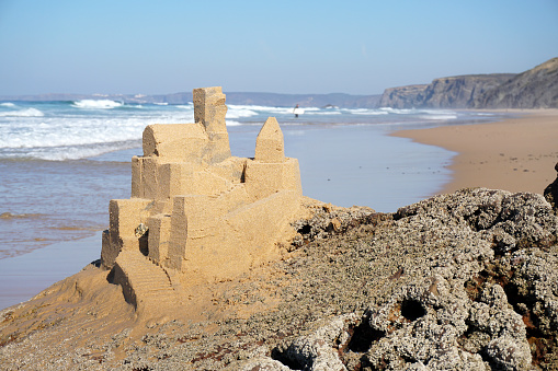 sand castle with many details built on rock at sandy beach