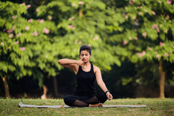 istock Young woman in practicing breathing exercise or Anulom Vilom at park 1315856076