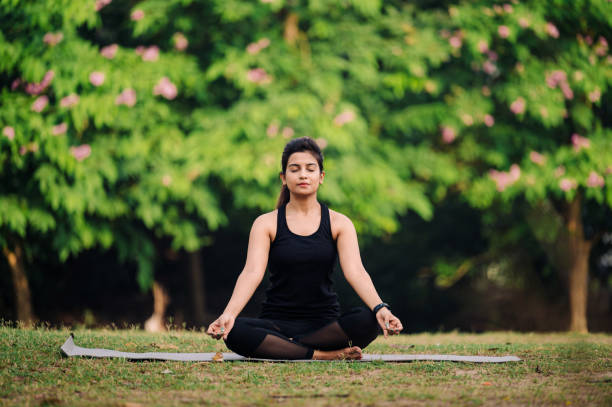 istock Young woman meditating outdoors at park 1315856127