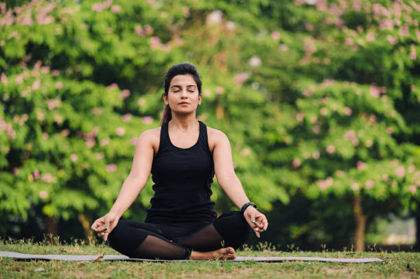istock Young woman meditating outdoors at park 1315856129