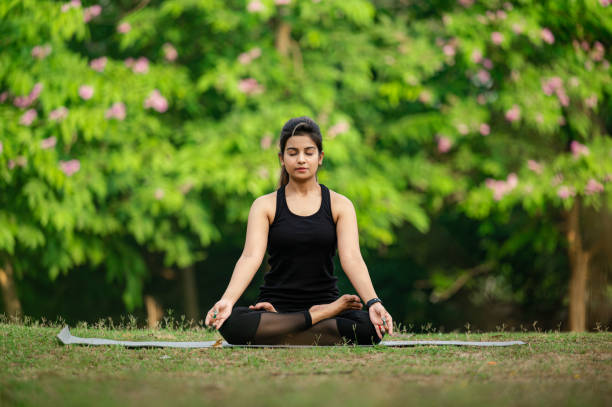 istock Young woman meditating outdoors at park 1315856227