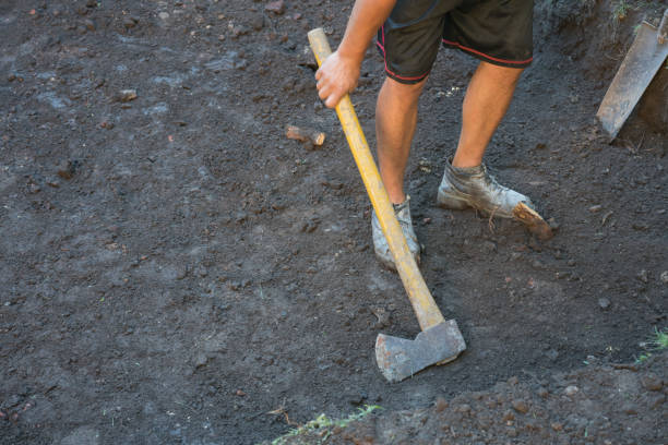 Detail of construction digging a hole at a house backyard.