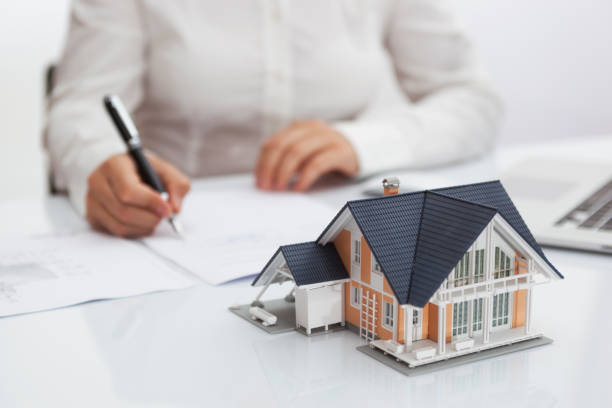 istock Woman Signing House Purchase Agreement 1315858053