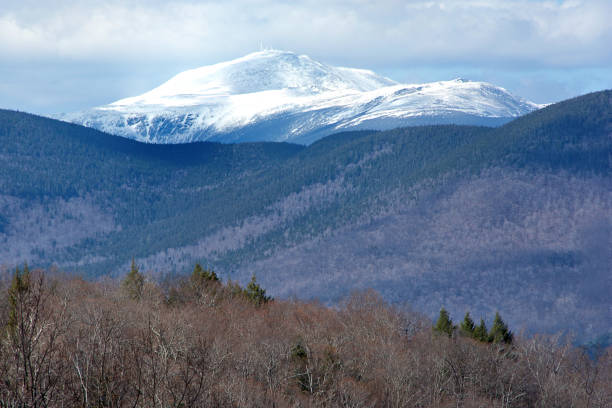 Scenic view from Bear Notch Road in White Mountains of New Hampshire. Rugged snow-capped summit of Mount Washington with weather observatory antennas at top of mountain.