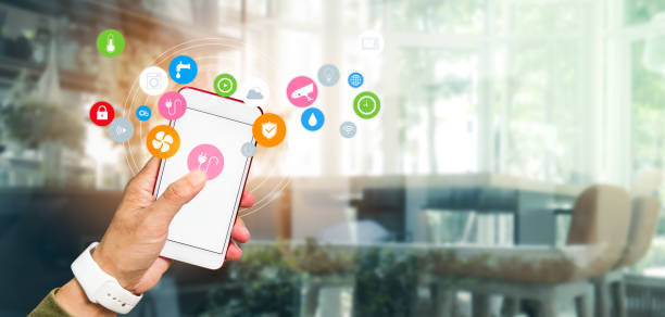 istock Man's hand using a smartphone controlling smart home automation assistant. Smart home concept 1315862543