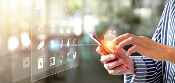 istock Man's hand using a smartphone controlling smart home automation assistant. Smart home concept 1315863358
