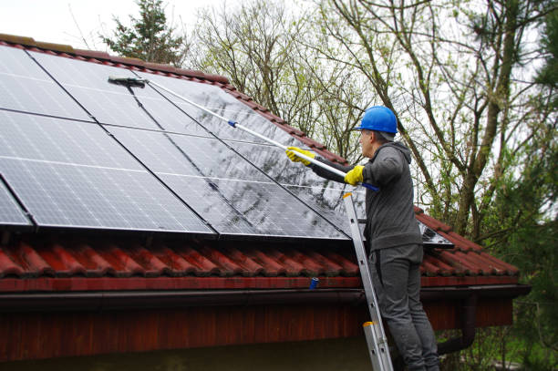 istock A man on a ladder cleaning solar panels 1315866305