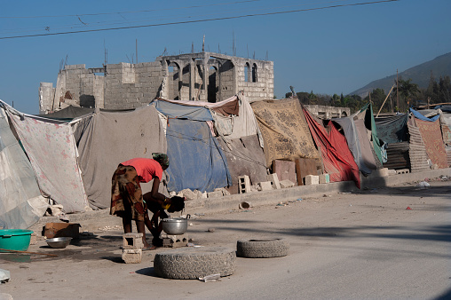 A mother washing her child in a makeshift camps and tents on a central reservation in Carrefour zone of Port-au-Prince, Haiti after the earthquake in January 2010