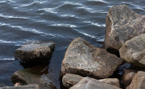 istock Closeup of rock bloulders on a river with wavelets 1315872718