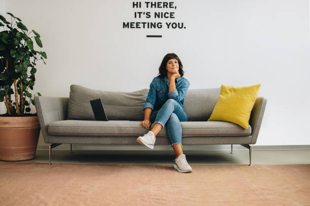 istock Confident woman sitting at office lobby 1315872911