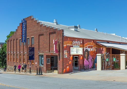 Asheville, NC, USA-1 May 2021: The Orange Peel, a live music venue on Biltmore Avenue. Front diagonal image of building with young people walking by on sidewalk.