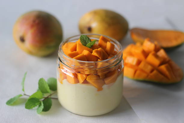 istock Vanilla custard topped with fresh cut mangoes served in a jar. 1315884591