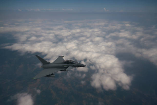 istock Jet Aircraft flying over clouds. 1315885622