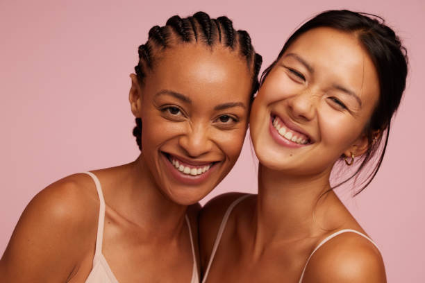 Natural Beauties with flawless skin Portrait of a cheerful young women looking at camera and smiling. Natural Beauties with fresh and clean skin diverse models stock pictures, royalty-free photos & images