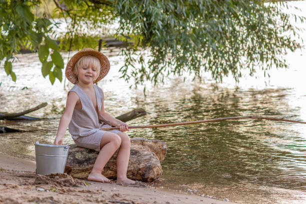 Little Asian boy fishing at the river vintage  retro