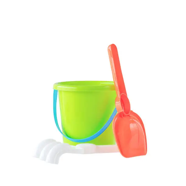 Baby toy bucket, shovel and rake isolated on white background. Beach objects isolated on white.
