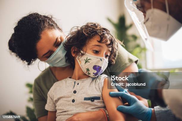 Kid Receiving Covid Vaccine At Home Stock Photo - Download Image Now - Child, Vaccination, Coronavirus
